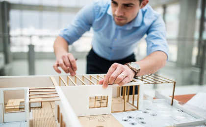 Architect reviewing a building model for a commercial design project
