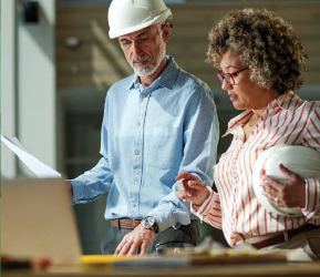 Construction professionals reviewing project plans and coating specifications on site